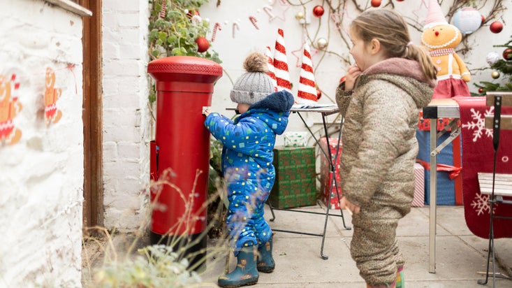 Children posting their letters to Father Christmas in the Conservatory at Christmas at Rowallane Garden, County Down
